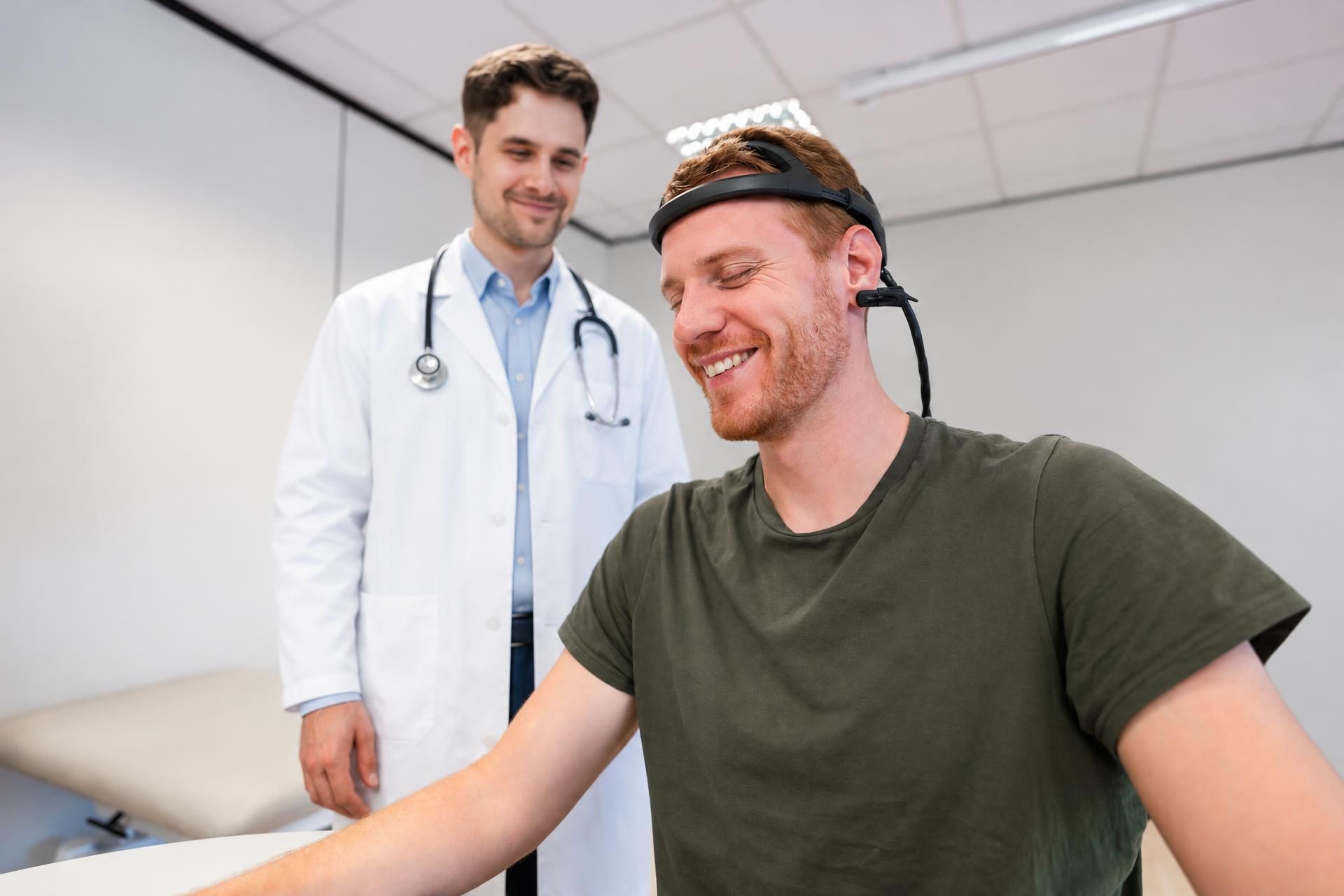 Physician with a smiling patient wearing a neurostimulation headset